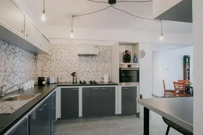 a kitchen with gray cabinets and a counter top at Lazaros Centre Apartment in Larnaka