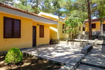 a house with yellow walls and a patio at Platres Valley Houses in Platres