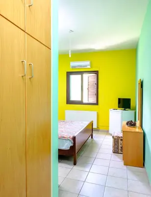 a room with a table and a room with yellow at Platres Valley Houses in Platres