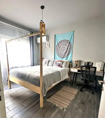 a bedroom with a canopy bed and a desk at Cheerful Apartment in Nicosia in Yukarı Lakatamya
