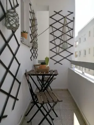 a room with a table and a chair on a wall at Cheerful Apartment in Nicosia in Yukarı Lakatamya