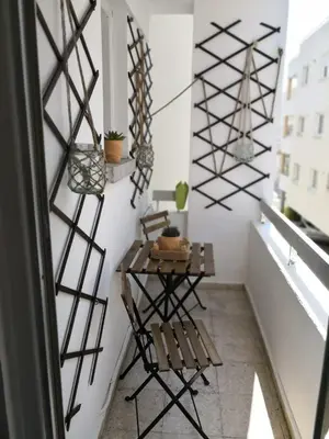 a small balcony with a bench and a table at Cheerful Apartment in Nicosia in Yukarı Lakatamya