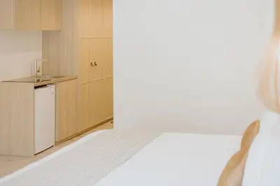 a bedroom with a bed and a small kitchen at Melissi Beach Hotel & Spa in Ayia Napa