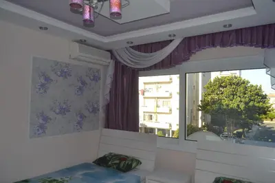 a room with a window and a couch and a bed at Двуспальная квартира возле дасуди in Limassol