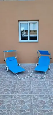 two blue chairs in a room with a window at Hermes Complex 2 Paralimni Cyprus in Paralimni