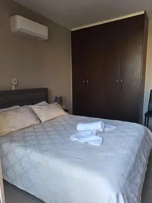 a bedroom with a bed with towels on it at Hermes Complex 2 Paralimni Cyprus in Paralimni