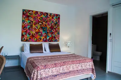 a bedroom with a bed with a painting on the wall at Idyllic studio with private pool in Nicosia
