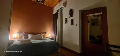 a bedroom with a large bed with two lights on at Petro's Antique House in Nicosia