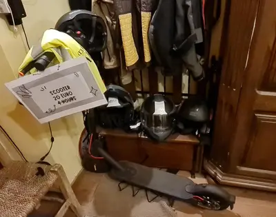 a pile ofhelmets and helmets on the floor with a sign at Petro's Antique House in Nicosia