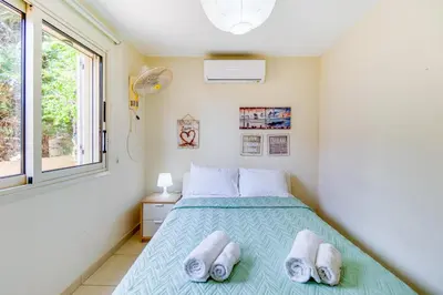 a bedroom with a bed with towels on it at Villa Venus by Ezoria Villas in Pervolia