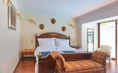 a bedroom with a bed and a couch and a window at Limassol Beachfront Holiday Villa in Limassol