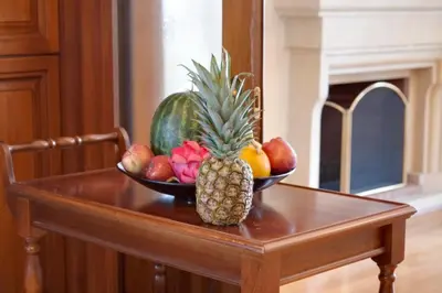 a bowl of fruit on a table with a pineapple at Limassol Beachfront Holiday Villa in Limassol