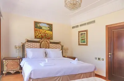 a bedroom with a bed with two towels on it at Limassol Beachfront Holiday Villa in Limassol