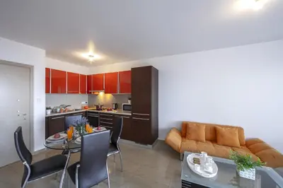a kitchen and living room with a couch and a table at one bedroom apartment in Fig tree bay in Protaras