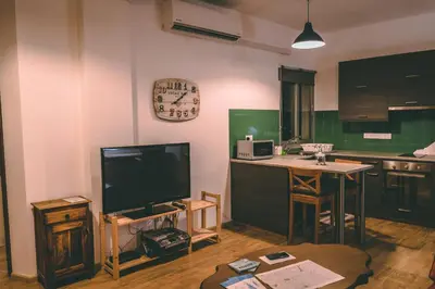 a living room with a tv and a kitchen at Cozy Flat City Center in Nicosia