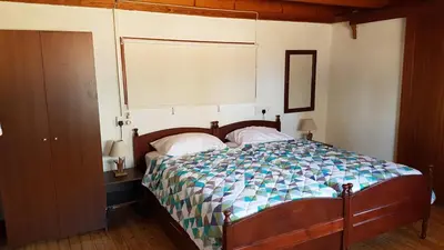 a bedroom with a bed with a wooden headboard at ZORBAS Sea View No 4 in Larnaka