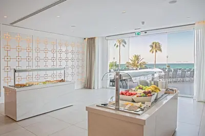 a kitchen with a counter with a bowl of fruit at Sunrise Beach Hotel in Protaras