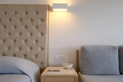 a bedroom with a bed and a chair and a table at Sunrise Beach Hotel in Protaras