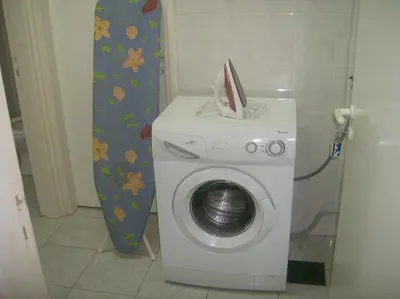 a washing machine in a bathroom next to a wall at Rantzo Holiday Apartments in Pissouri