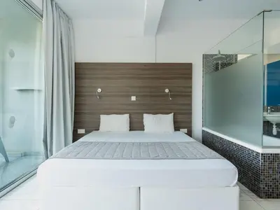 a bedroom with a large bed with a wooden headboard at Rio Gardens Aparthotel in Ayia Napa