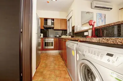 a kitchen with a washer and dryer at Seafront Protaras Apartments in Protaras