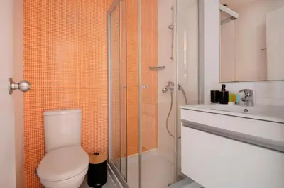 a bathroom with a toilet and a shower and a sink at UC Hall Residence in Nicosia