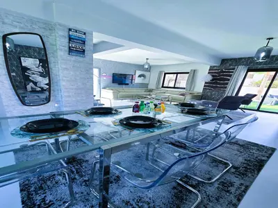 a glass table with four chairs in a room at 3 Bedroom Villa, private pool, hot tub in Protaras