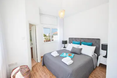 a bedroom with a bed with two trays on it at Marimar villa in Protaras