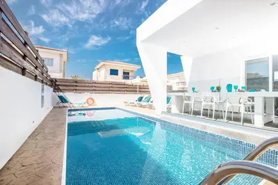 a swimming pool in a villa with blue water at Marimar villa in Protaras