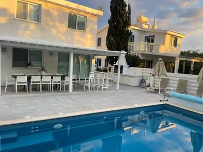 a villa with a swimming pool and a house at Konnos Hight Villa in Protaras