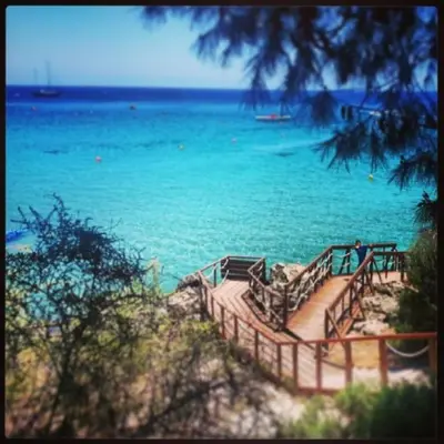 a staircase leading to the beach with the ocean at Konnos Hight Villa in Protaras