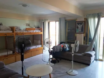 a living room with a bed and a couch at NEX Hostel in Nicosia