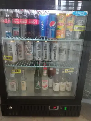 a refrigerator filled with lots of drinks and sodas at NEX Hostel in Nicosia