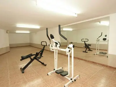 a gym with several exercise bikes and a mirror at Patatas Villa in Limassol