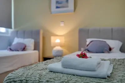 a hotel room with two beds with towels on the bed at Atlantis Apartments 50m from Makenzy seafront in Larnaka