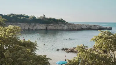 a group of people in the water at a beach at The Blue Mile w Jacuzzi in Paralimni