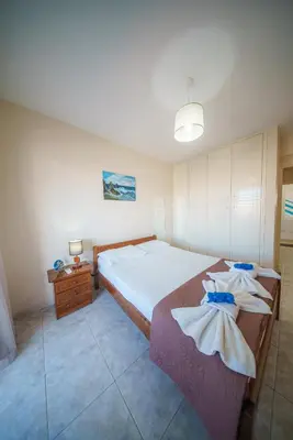 a bedroom with a large bed with towels on it at The Valley Beyond in Paralimni