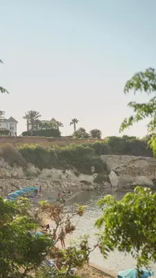 a group of people on a beach near a river at The Valley Beyond in Paralimni