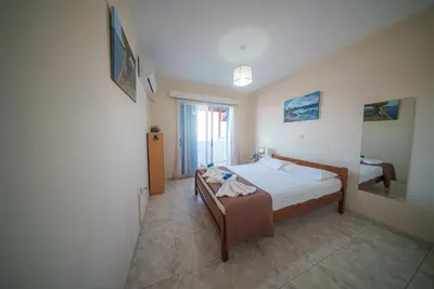 a bedroom with a bed and a table in it at The Valley Beyond in Paralimni