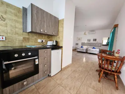 a kitchen with a stove and a counter top at Florence Hotel Apartments in Ayia Napa