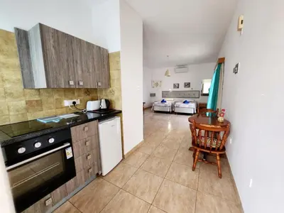 a kitchen with a table and a counter top at Florence Hotel Apartments in Ayia Napa