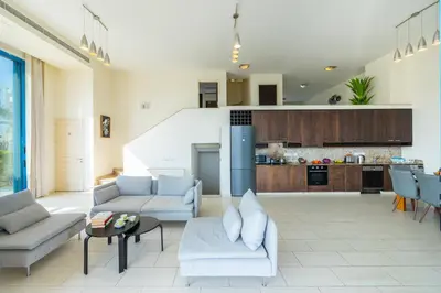 a living room with couches and a kitchen at Infinity Villa in Protaras