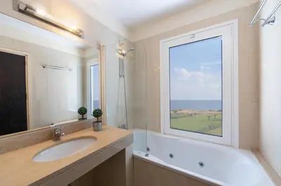 a bathroom with a sink and a large window at Infinity Villa in Protaras