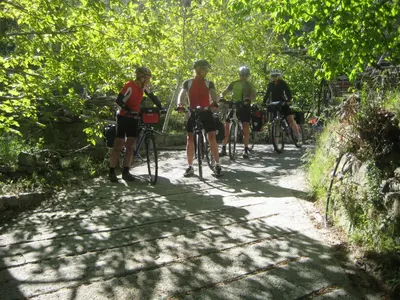 a group of people riding bikes down a trail at Flora's House in Spilia