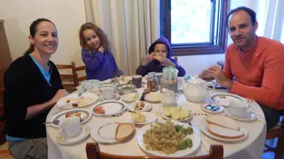 a group of people sitting around a table with food at Flora's House in Spilia