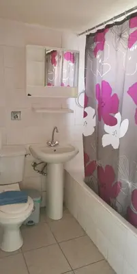 a bathroom with a sink and a toilet and a shower curtain at Simos Magic Hotel Apts in Ayia Napa