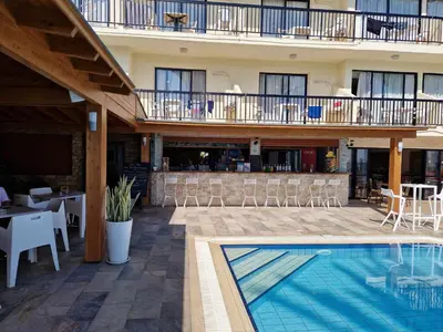 a hotel with a swimming pool and a restaurant at Simos Magic Beach Hotel Apts in Ayia Napa