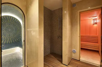 a bathroom with a tub and a walk in shower at Opera Exclusive Apts by TrulyCyprus in Limassol