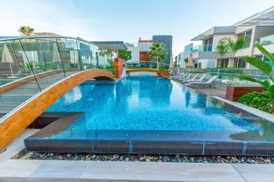 a large swimming pool with a bridge over it at Opera Exclusive Apts by TrulyCyprus in Limassol