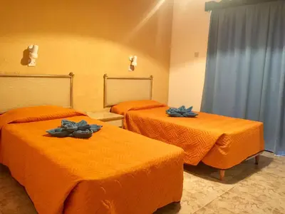 two beds in a room with blue bows on them at Carina Hotel Apartments in Ayia Napa